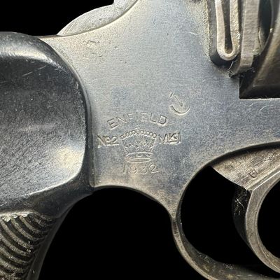 Sale Photo Thumbnail #165: The Enfield No. 2 is a British top break double action revolver using the .38 S&W round manufactured from 1930 to 1957. It was the standard British/Empire sidearm in the Second World War. It holds six rounds, has Bakelite grips, and has a five inch barrel