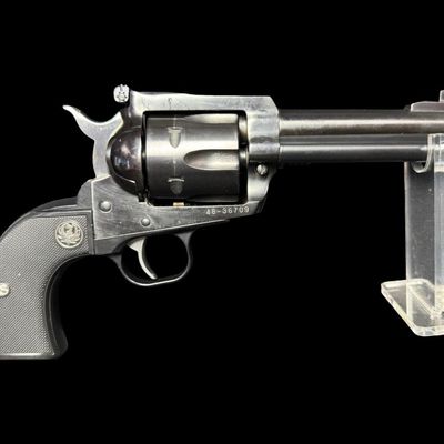 Sale Photo Thumbnail #174: This Single Six fires the Remington caliber .41 magnum. It has a six round capacity. It has a fully windage and elevation rear sight. It is made from alloy steel with a blued finish, and has polymer grips. The barrel length is 4.62 inches. Also included i