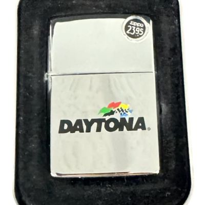 Sale Photo Thumbnail #204: Includes an NOS Daytona 500 Zippo lighter in the original packaging, and a vintage Zippo guarantee card. The lighter is from the 1998 Daytona 500. Pre-auction estimate: $75-$100. [RS]