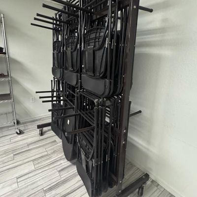 Sale Photo Thumbnail #241: Includes 40 folding chairs on a rolling storage rack. The rack measures 6’ high, by 5’ wide. [RS]