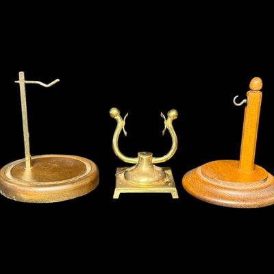Sale Photo Thumbnail #296: Includes a vintage brass pocket watch stand, and two domed pocket watch displays. Measurement of largest: 6”H. [RS]