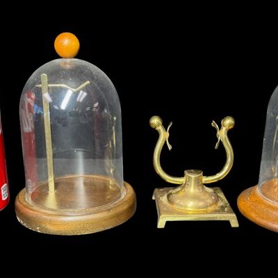 Sale Photo Thumbnail #297: Includes a vintage brass pocket watch stand, and two domed pocket watch displays. Measurement of largest: 6”H. [RS]