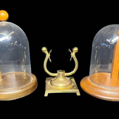 Sale Photo Thumbnail #295: Includes a vintage brass pocket watch stand, and two domed pocket watch displays. Measurement of largest: 6”H. [RS]
