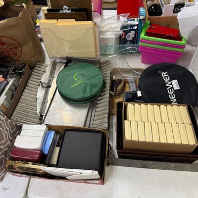 Sale Photo Thumbnail #407: Includes jewelry props, jewelry bags, jewelry boxes, and other jewelry supplies. Also includes storage, electrical cords, multi-plugs, binders, folders, light bulbs, a 1920s miniature metal airplane hangar, first aid supplies, glycine bags, and so much mo