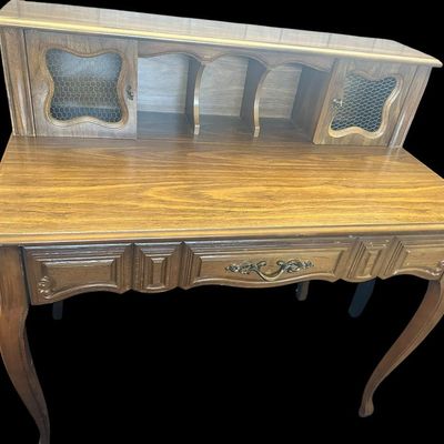Sale Photo Thumbnail #58: 39.50"T × 40"W × 22"D French Country / Provincial Style Desk with Wire-Insert Hutch  features upper hutch with center storage cubbies and dual cabinet doors with chicken wire mesh inserts  molded center drawer with ornamental brass bail handle  and cabr