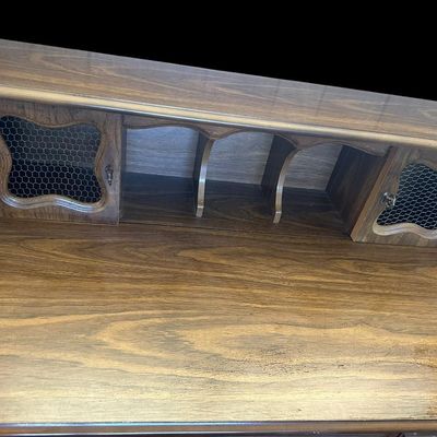 Sale Photo Thumbnail #59: 39.50"T × 40"W × 22"D French Country / Provincial Style Desk with Wire-Insert Hutch  features upper hutch with center storage cubbies and dual cabinet doors with chicken wire mesh inserts  molded center drawer with ornamental brass bail handle  and cabr