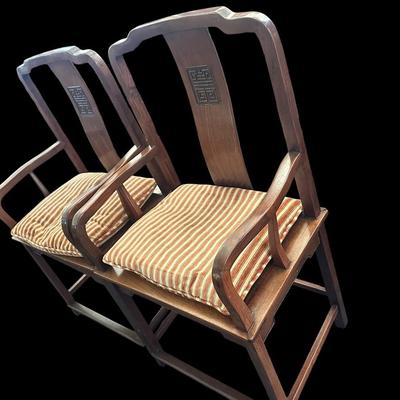 Sale Photo Thumbnail #81: 42.75"T  29" arm ht  20.5" seat ht  23" seat width Solid hardwood construction featuring curved yoke top crests  back splats carved with character medallion longevity symbols  slatted armrests  box stretcher bases  and removable striped seat cushions Chin