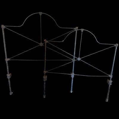 Sale Photo Thumbnail #86: Vintage dark iron twin bed frame. Includes arched headboard featuring high-back headboard with carved crest scrollwork  horizontal wood paneling  and matching carved footboa  Footboard with cross-bracing  plus side rails. Shows age and some surface wear. 