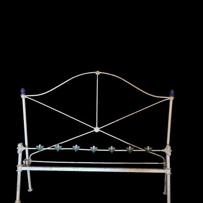 Sale Photo Thumbnail #94: Vintage full sized painted wrought iron full size headboard featuring an arched crest frame  cross-brace geometric support  purple finial accents  and colorful painted floral tile emblems across lower crossbar.  