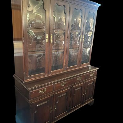 Sale Photo Thumbnail #106: 80 x 20 x 60 Solid mahogany construction featuring four upper cabinet doors with distinct curved/convex glass panes  molded dentil trim  four center drawer storage bays  and four lower raised-panel cabinet doors with brass bail hardware.80 x 20 x 60  
