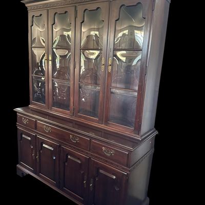 Sale Photo Thumbnail #107: 80 x 20 x 60 Solid mahogany construction featuring four upper cabinet doors with distinct curved/convex glass panes  molded dentil trim  four center drawer storage bays  and four lower raised-panel cabinet doors with brass bail hardware.80 x 20 x 60  