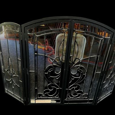 Sale Photo Thumbnail #159: Center 28.50 Sides 13.00 Total 42.00 Ornate 4-panel folding fireplace screen featuring heavy black metal frame  clear leaded glass panes with beveled edges  and Fleur-de-Lis stylized center motif. Center 28.50 Sides 13.00 Total 42.00  