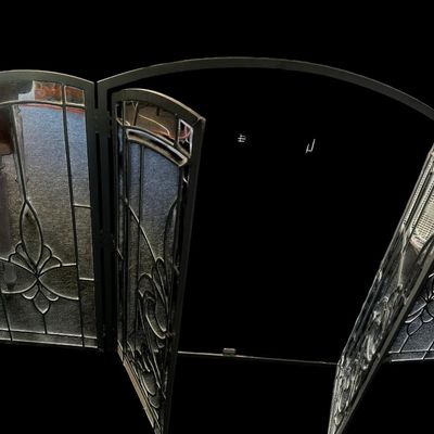 Sale Photo Thumbnail #160: Center 28.50 Sides 13.00 Total 42.00 Ornate 4-panel folding fireplace screen featuring heavy black metal frame  clear leaded glass panes with beveled edges  and Fleur-de-Lis stylized center motif. Center 28.50 Sides 13.00 Total 42.00  