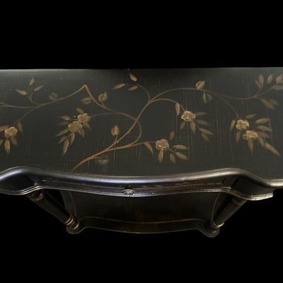Sale Photo Thumbnail #255: 36"W × 12"D × 30.5"T Traditional demilune wall console table featuring a distressed black finish  hand-painted gold floral branch motifs across the top and single drawer front  turned fluted legs  and lower display shelf tier. Dimensions: 36" Wide x 12"