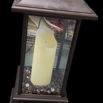 Sale Photo Thumbnail #366: Duraflame 28-inch heavy-duty infrared quartz electric lantern heater (Model AZ-82040 / 10ILH117 series) in a bronze finish. Features a 1400W/1500W infrared heating element (heats up to 1,000 sq ft), flickering LED pillar candle over amber glass rocks, tou