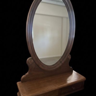 Sale Photo Thumbnail #378: Antique solid oak tabletop vanity mirror featuring a large oval tilting mirror frame mounted on a wooden plinth base with two integrated trinket/glove drawers with original wooden knobs. Items may be held with pre-payment or a deposit. We are not scammers