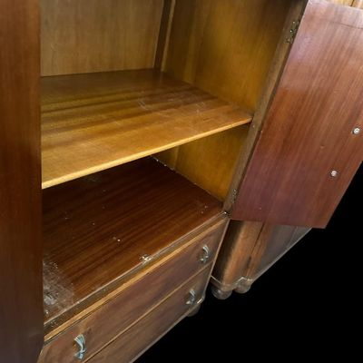 Sale Photo Thumbnail #470: 48"T × 29"W × 18"D Oak cabinet with two upper doors (carved center panel with vertical slats and floral detail)  two lower drawers  and bun feet. Interior has a shelf. Measurements: 48" tall × 29" wide × 18" deep. Local  .  