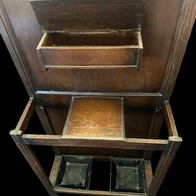 Sale Photo Thumbnail #494: 72 X 28 X 9.50 Central octagonal beveled mirror  upper double hat/coat hooks  small center glove box with hinged lid  umbrella/cane storage rails with removable metal drip pans at base. Retains original gold foil "Lawrencia" maker's trade mark label. 72 X