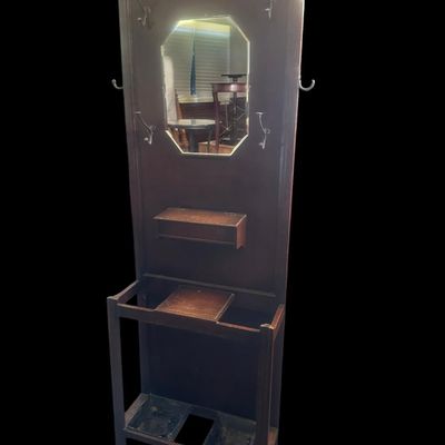 Sale Photo Thumbnail #491: 72 X 28 X 9.50 Central octagonal beveled mirror  upper double hat/coat hooks  small center glove box with hinged lid  umbrella/cane storage rails with removable metal drip pans at base. Retains original gold foil "Lawrencia" maker's trade mark label. 72 X