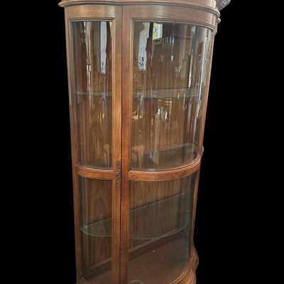 Sale Photo Thumbnail #500: 70 X 41 X 17 Serpentine curved glass front and sides  molded top cornice  wood frame  full glass display shelving  and brass pull handle.  