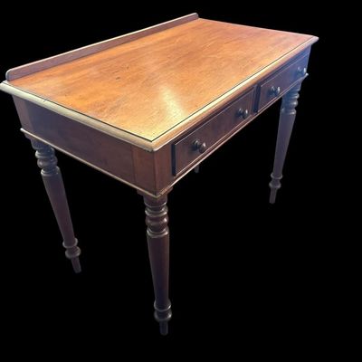 Sale Photo Thumbnail #504: 31 X 23 X 48 Antique Colonial Style Walnut 2-Drawer Writing Desk  features low back gallery guard rail  2 drawers with wooden turn knobs  turned spindle legs  and solid wood construction with light surface age patina.  