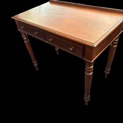 Sale Photo Thumbnail #502: 31 X 23 X 48 Antique Colonial Style Walnut 2-Drawer Writing Desk  features low back gallery guard rail  2 drawers with wooden turn knobs  turned spindle legs  and solid wood construction with light surface age patina.  