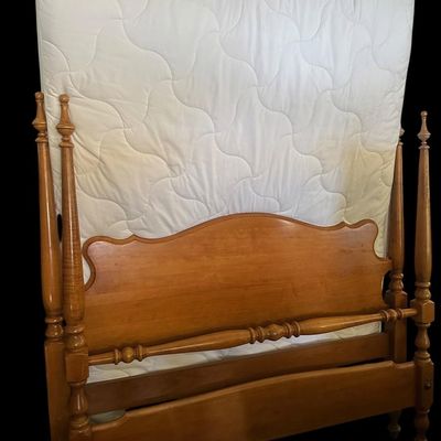 Sale Photo Thumbnail #519: Solid maple full size bed featuring four turned urn/cannonball corner posts  shaped arched headboard panel  turned spindle blanket rail  wooden side rails  and clean quilted mattress. 