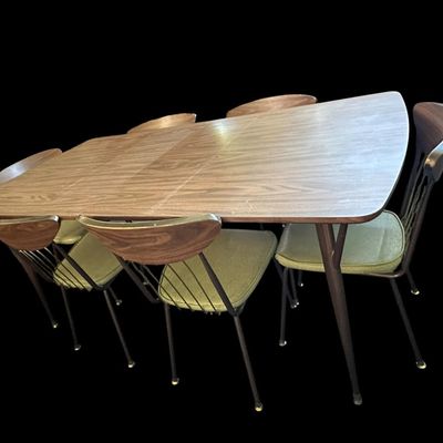 Sale Photo Thumbnail #585: 29.50 Tall 70.50 Long (w/leaves) 46.00 (w/o leaves) 35.50 Wide 11.50 (each leaf) MCM dining set featuring walnut-tone laminate rectangular table with extension leaf and tapered black metal legs with brass ferrule feet  paired with 6 matching chairs featur