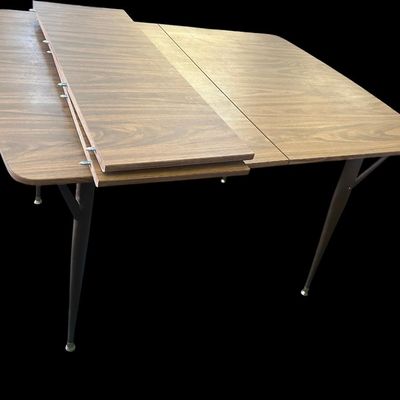 Sale Photo Thumbnail #595: 29.50 Tall 70.50 Long (w/leaves) 46.00 (w/o leaves) 35.50 Wide 11.50 (each leaf) MCM dining set featuring walnut-tone laminate rectangular table with extension leaf and tapered black metal legs with brass ferrule feet  paired with 6 matching chairs featur