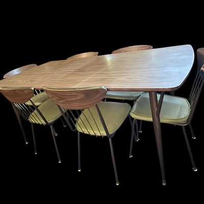 Sale Photo Thumbnail #586: 29.50 Tall 70.50 Long (w/leaves) 46.00 (w/o leaves) 35.50 Wide 11.50 (each leaf) MCM dining set featuring walnut-tone laminate rectangular table with extension leaf and tapered black metal legs with brass ferrule feet  paired with 6 matching chairs featur