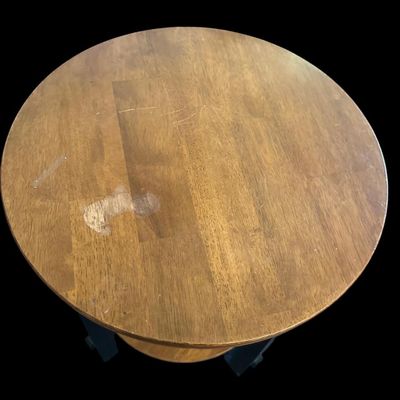 Sale Photo Thumbnail #741: 26.00 Tall 19.50 Round Round wood end table with a warm natural wood grain top and lower shelf paired with distressed black square legs. 26.00 Tall 19.50 Round  