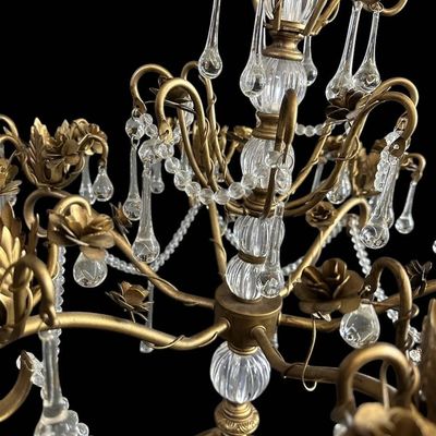 Sale Photo Thumbnail #920: Vintage Hollywood Regency style decorative tabletop centerpiece (epergne style) in an antique gold gilt finish. Features a central fluted glass urn column supporting sweeping scrolled brass arms adorned with dimensional carved brass rose blooms and foliag
