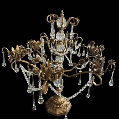 Sale Photo Thumbnail #916: Vintage Hollywood Regency style decorative tabletop centerpiece (epergne style) in an antique gold gilt finish. Features a central fluted glass urn column supporting sweeping scrolled brass arms adorned with dimensional carved brass rose blooms and foliag