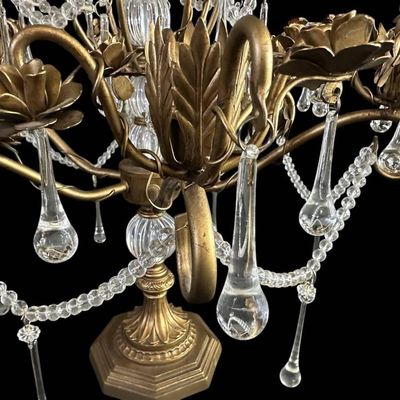 Sale Photo Thumbnail #919: Vintage Hollywood Regency style decorative tabletop centerpiece (epergne style) in an antique gold gilt finish. Features a central fluted glass urn column supporting sweeping scrolled brass arms adorned with dimensional carved brass rose blooms and foliag