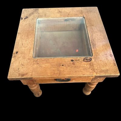 Sale Photo Thumbnail #927: 21"T × 24"W × 24"D Rustic solid wood end table featuring inset glass top pane  single storage drawer with dark iron drop ring pull  and thick turned baluster legs. Dimensions: 21" Tall x 24" Wide x 24" Deep.  