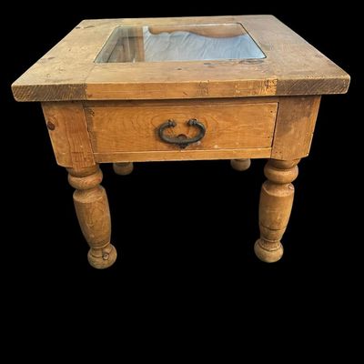 Sale Photo Thumbnail #926: 21"T × 24"W × 24"D Rustic solid wood end table featuring inset glass top pane  single storage drawer with dark iron drop ring pull  and thick turned baluster legs. Dimensions: 21" Tall x 24" Wide x 24" Deep.  