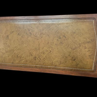 Sale Photo Thumbnail #930: 42"L × 21"D × 16.5"T Traditional coffee table featuring gold-tooled leather top inlay  Dimensions: 42" Long x 21" Deep x 16.50" Tall.  