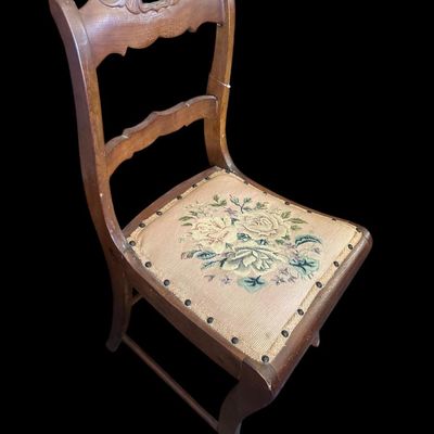 Sale Photo Thumbnail #939: Antique carved solid oak side chair featuring hand-carved crest rail  fiddle backrest splat  curved cabriole legs  and brass-tacked floral needlepoint tapestry seat cushion.  