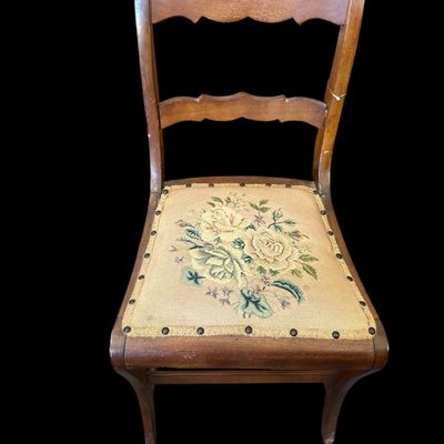 Sale Photo Thumbnail #938: Antique carved solid oak side chair featuring hand-carved crest rail  fiddle backrest splat  curved cabriole legs  and brass-tacked floral needlepoint tapestry seat cushion.  