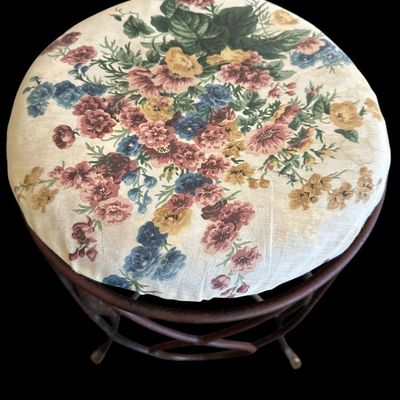 Sale Photo Thumbnail #941: Round vanity stool featuring a dark metal base with looping wire scrollwork  stretcher ring support  and padded floral chintz fabric seat cushion.  