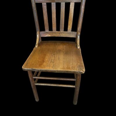 Sale Photo Thumbnail #943: Antique solid oak side chair featuring top crest rail  vertical back slats  side support brackets  and solid wood seat with age patina.  