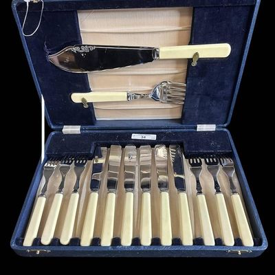 Sale Photo Thumbnail #947:  Vintage Stainless Steel Fish Set With Cream-Colored Handles and Case.                           