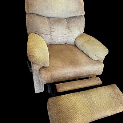 Sale Photo Thumbnail #955: Very clean overstuffed stationary recliner chair upholstered in ribbed tan/taupe corduroy fabric featuring plush pillow-top armrests  segmented back support  and side lever extendable footrest.  