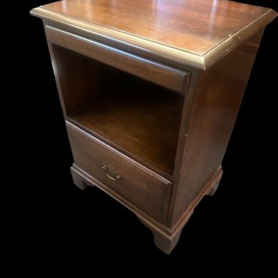 Sale Photo Thumbnail #959: 27.00 x 19 x 14.50 Solid wood end table/nightstand in warm mahogany finish featuring top slide-out tray  open middle display cubby section  lower drawer with brass bail handle  and bracket feet. 27.00 x 19 x 14.50  