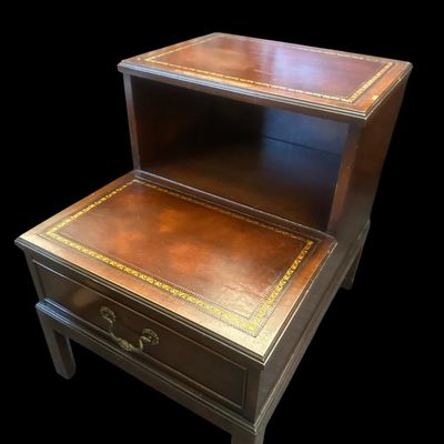 Sale Photo Thumbnail #964: 25.50 x 17.75 x 29.00 Traditional two-tier step-down end table featuring gold-embossed leather top surfaces  open middle cubby bay  lower drawer with brass swan-neck pull handle  and dovetail joinery 25.50 x 17.75 x 29.00  