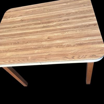 Sale Photo Thumbnail #977: 36"L × 28"D × 28.5"T Small retro feel dining/utility table featuring faux wood grain laminate top with white trim edge and solid wood square legs. Dimensions: 28.50" Tall x 36" Long x 28" Deep.  