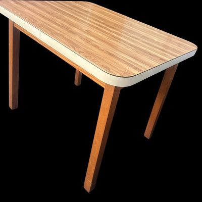 Sale Photo Thumbnail #978: 36"L × 28"D × 28.5"T Small retro feel dining/utility table featuring faux wood grain laminate top with white trim edge and solid wood square legs. Dimensions: 28.50" Tall x 36" Long x 28" Deep.  