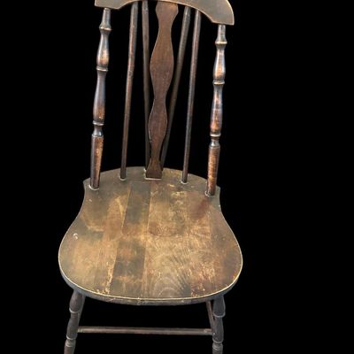 Sale Photo Thumbnail #982: Dark wood Windsor-style chair with spindle back  curved crest rail  and solid seat. Shows age and wear. Local   only.  