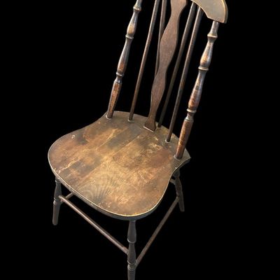 Sale Photo Thumbnail #983: Dark wood Windsor-style chair with spindle back  curved crest rail  and solid seat. Shows age and wear. Local   only.  