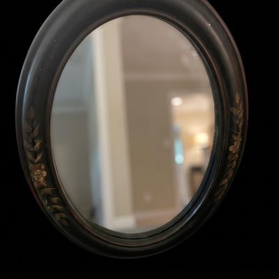 Sale Photo Thumbnail #985: Vertical oval wall mirror framed in a smooth deep-set matte black composite frame.  